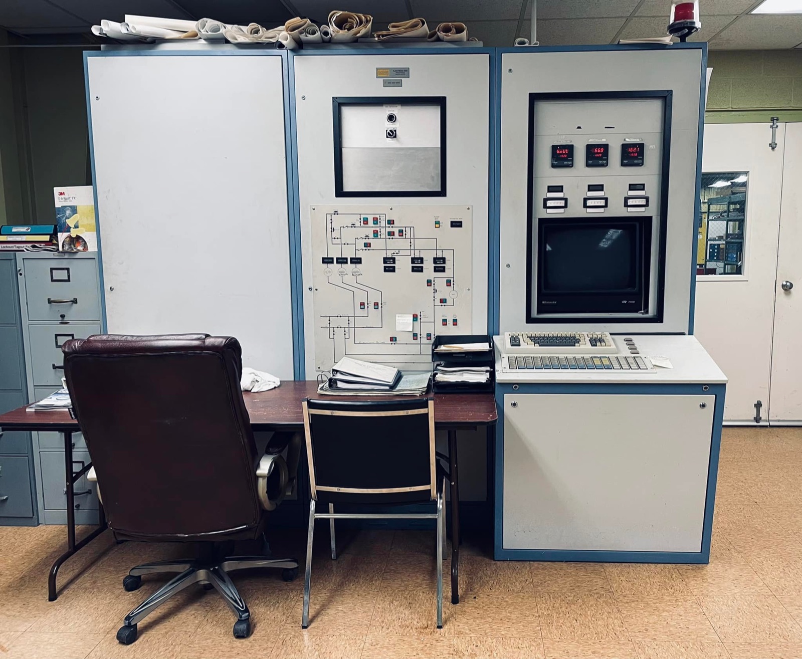 Vintage industrial control room console with process schematic