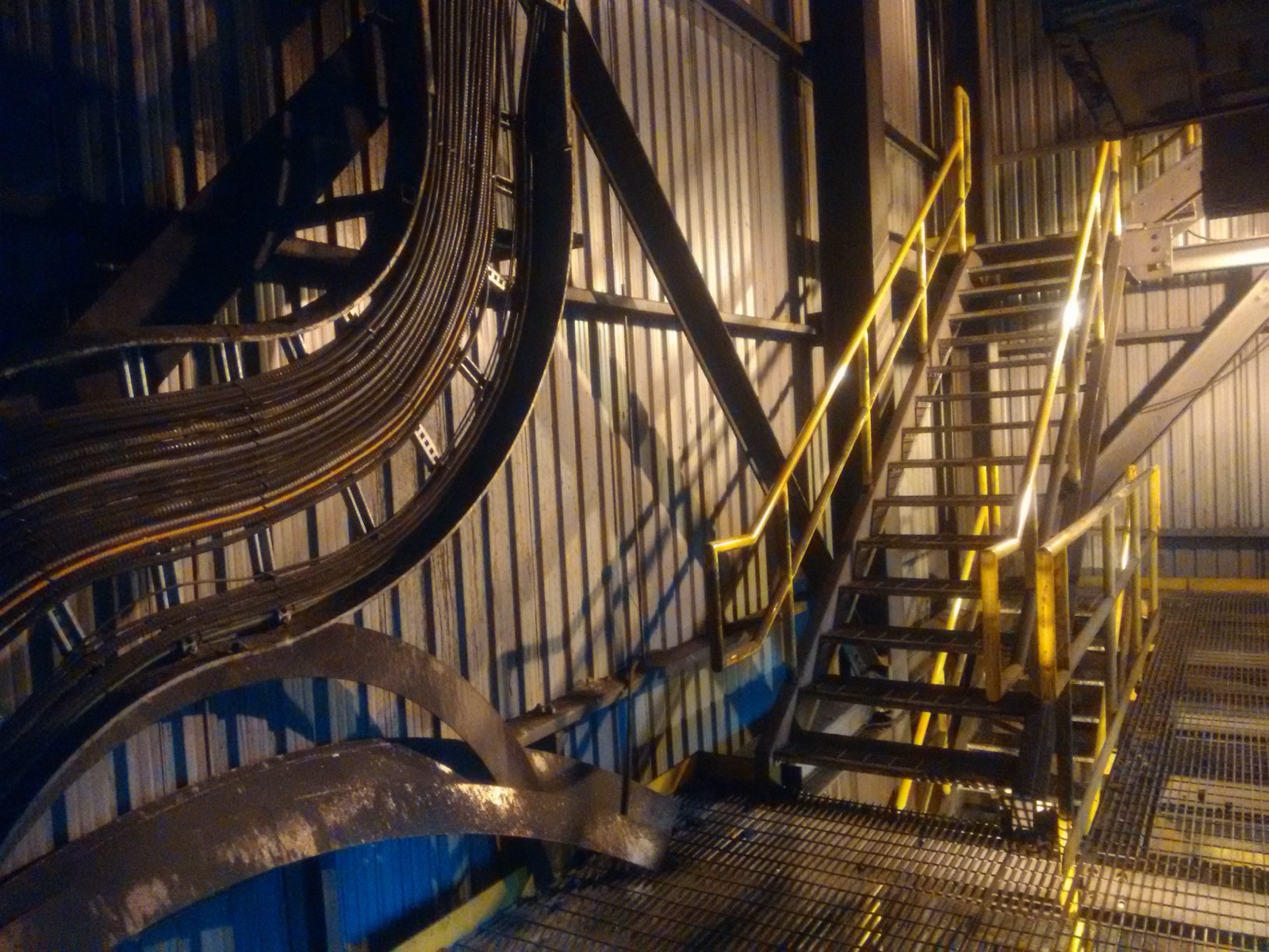 Industrial plant interior with steel stairs and ductwork