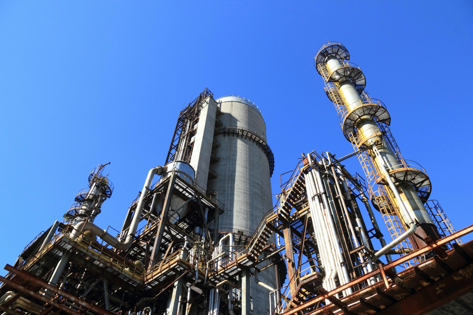Process plant towers against a blue sky